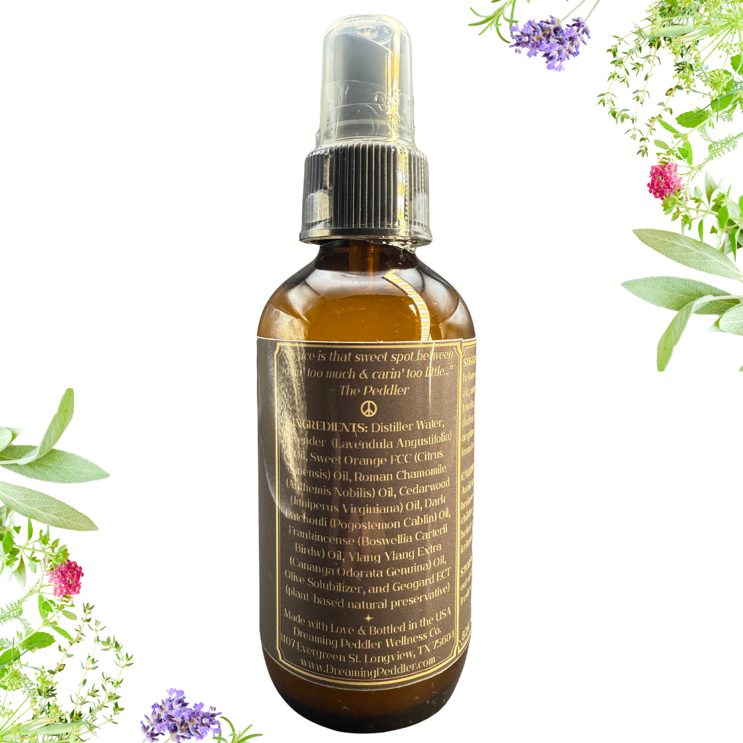 Bottle of essential oil spray with botanical elements on a white background